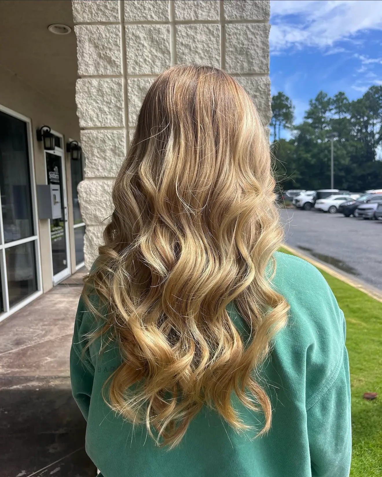 Blonde balayage with soft waves by Davis White Salon
