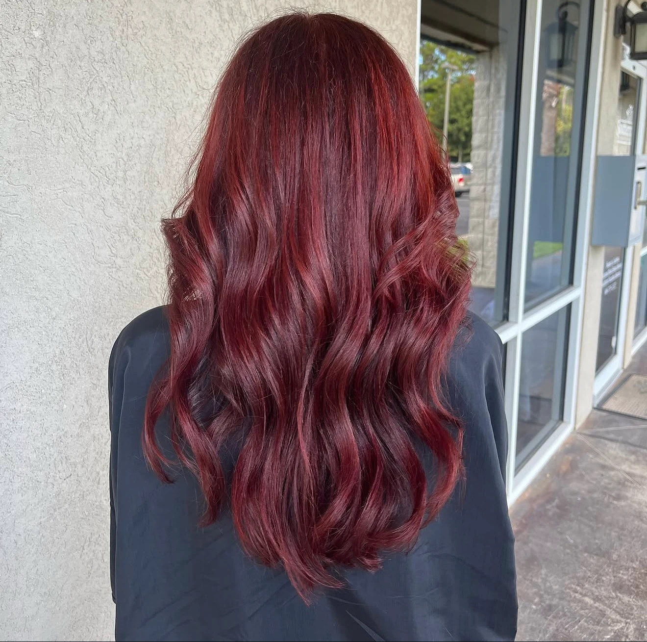 Rich red color with long waves by Davis White Salon