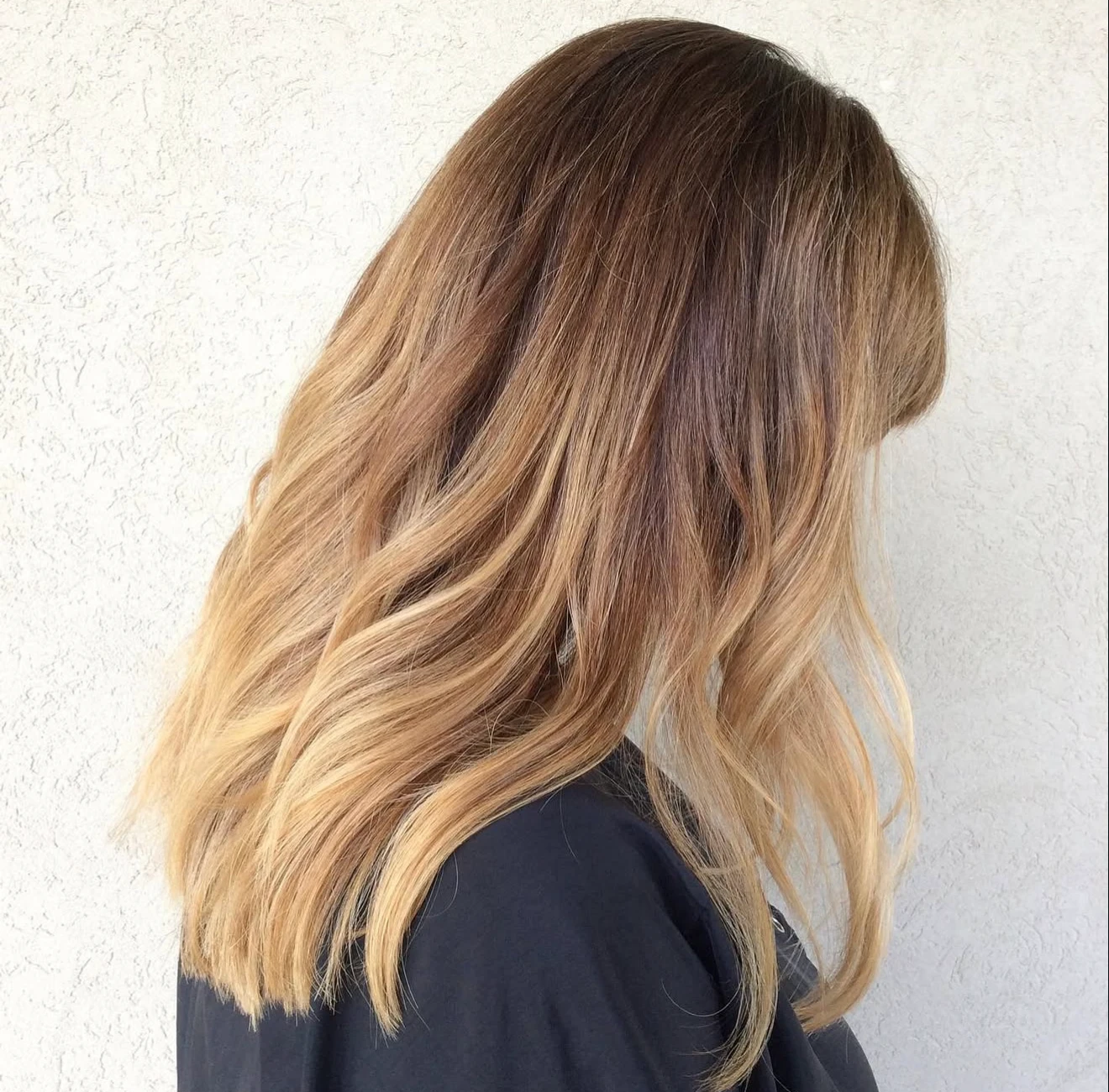 Warm bronde ombré with layered waves by Davis White Salon